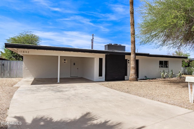 11842 N 30th Dr, Phoenix, AZ 85029 - view of front of home with fence, an attached carport, stucco siding, and concrete driveway