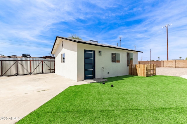 11842 N 30th Dr, Phoenix, AZ 85029 - back of house with a yard, stucco siding, a patio, fence, and a gate