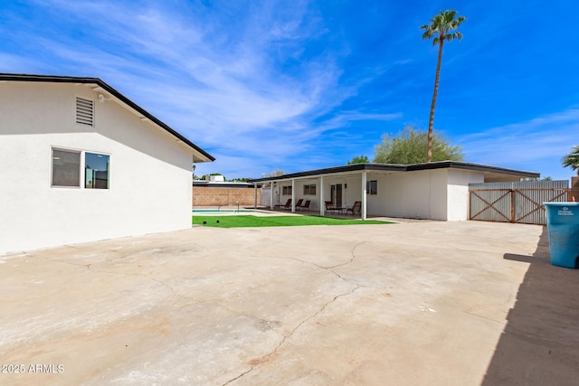 11842 N 30th Dr, Phoenix, AZ 85029 - rear view of house featuring a gate, fence, a patio, and stucco siding