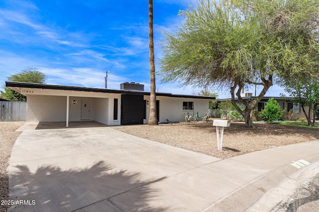 11842 N 30th Dr, Phoenix, AZ 85029 - ranch-style house with central air condition unit, a carport, driveway, and stucco siding
