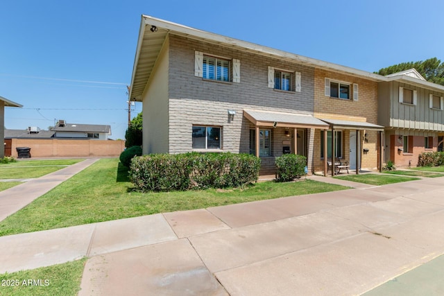 4629 S Mill Ave, Tempe, AZ 85282 - view of property featuring a porch, a front yard, brick siding, board and batten siding, and stone siding