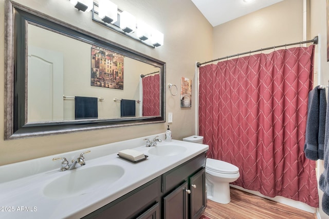 bathroom with toilet, vanity, walk in shower, and hardwood / wood-style flooring