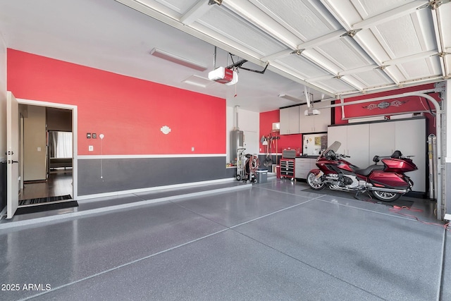 garage with water heater and a garage door opener