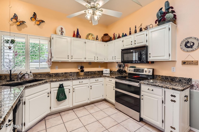 kitchen with a sink, range with two ovens, a ceiling fan, black microwave, and white cabinetry