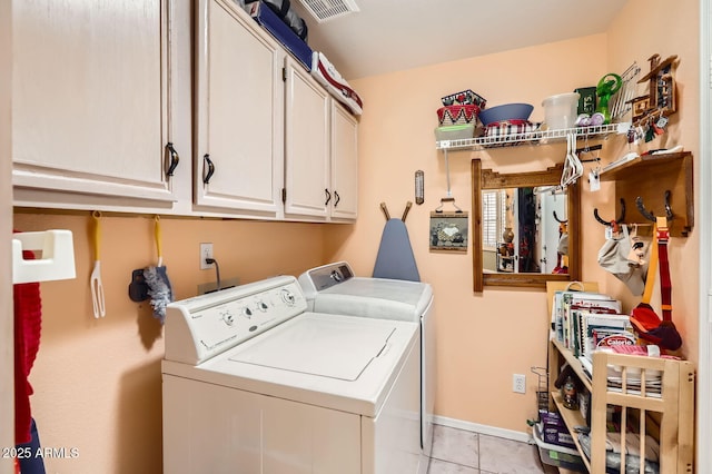 laundry area with cabinet space, independent washer and dryer, light tile patterned flooring, visible vents, and baseboards