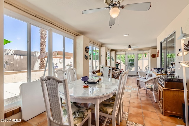 dining space with light tile patterned floors and a ceiling fan