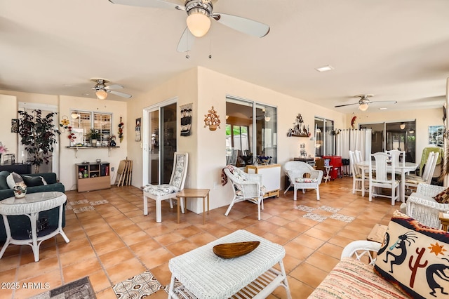 living room with light tile patterned floors and ceiling fan