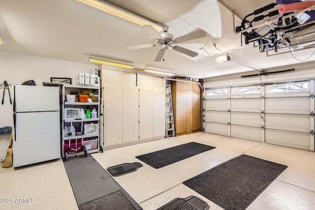 garage featuring a garage door opener, ceiling fan, and freestanding refrigerator