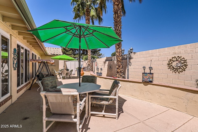 view of patio / terrace with outdoor dining space and a fenced backyard