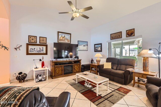 tiled living area with high vaulted ceiling and ceiling fan
