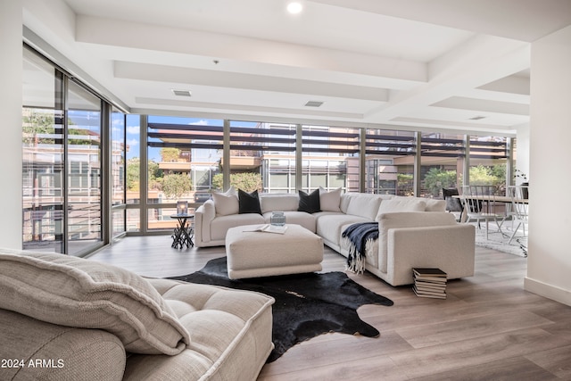 living room featuring light hardwood / wood-style flooring, floor to ceiling windows, and beamed ceiling