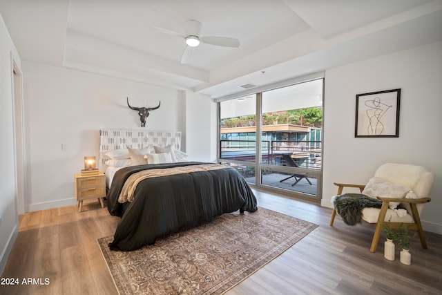 bedroom with light hardwood / wood-style flooring, ceiling fan, and access to exterior