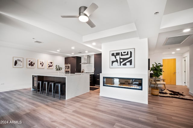 living room with light hardwood / wood-style floors and ceiling fan