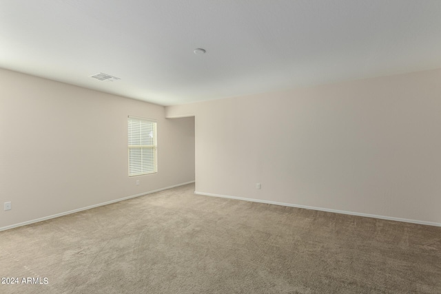 empty room featuring light colored carpet