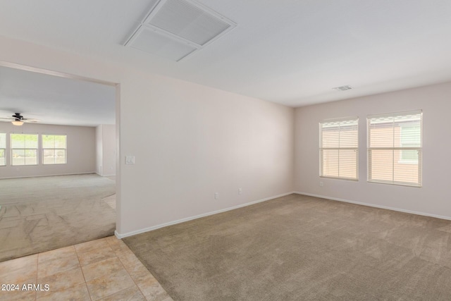 carpeted spare room with ceiling fan