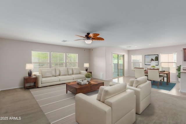 living room featuring ceiling fan and plenty of natural light