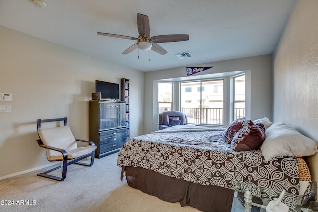 bedroom with ceiling fan and light carpet