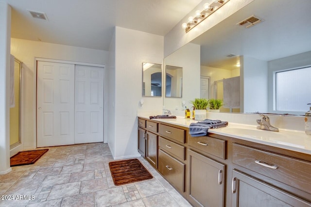 bathroom with tile patterned flooring, an enclosed shower, and vanity