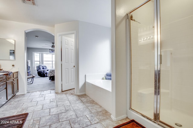 bathroom with ceiling fan, tile patterned flooring, plus walk in shower, and vanity