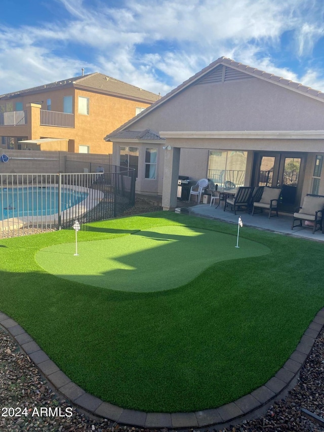 view of property's community featuring a swimming pool and a patio area