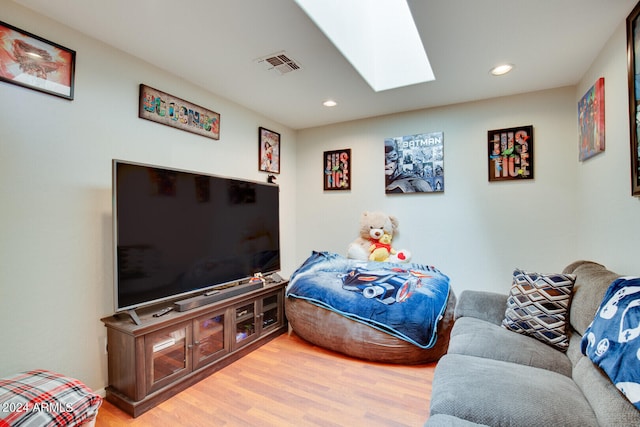 bedroom featuring hardwood / wood-style floors and a skylight