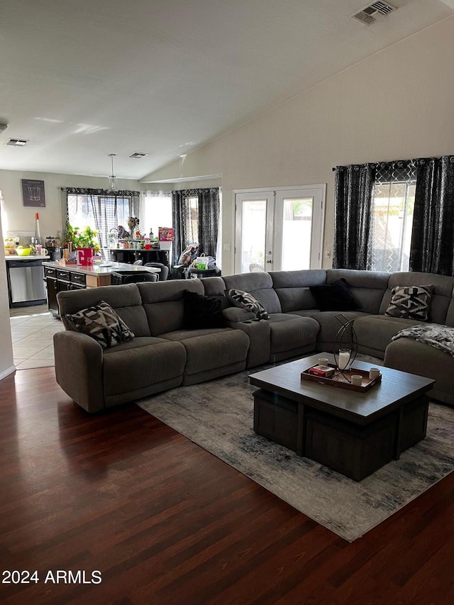 living room with vaulted ceiling, french doors, and tile patterned floors