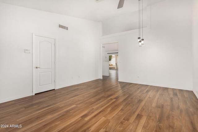 empty room with ceiling fan and wood-type flooring