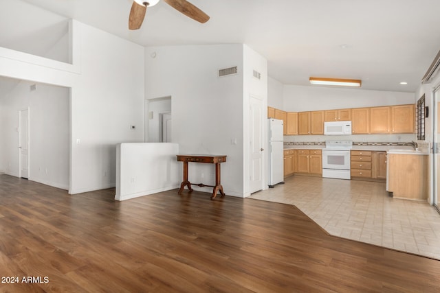 kitchen with high vaulted ceiling, white appliances, light brown cabinets, tile patterned flooring, and ceiling fan