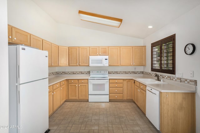 kitchen featuring sink, white appliances, vaulted ceiling, light brown cabinets, and light tile patterned floors