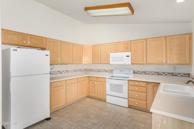 kitchen featuring white appliances and light brown cabinetry