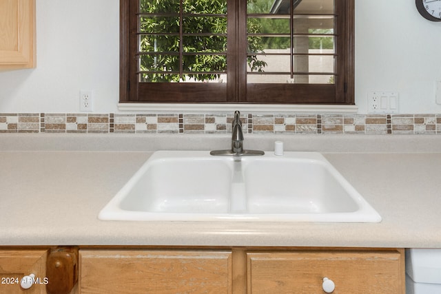 interior details featuring sink and light brown cabinetry