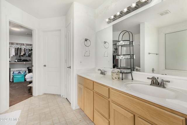 bathroom with tile patterned flooring and vanity