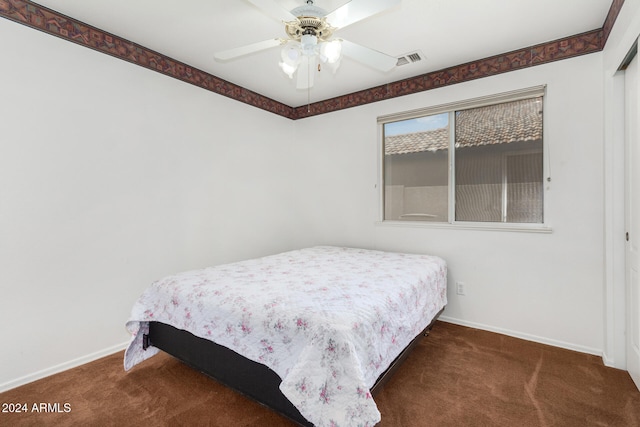 bedroom featuring ceiling fan and carpet