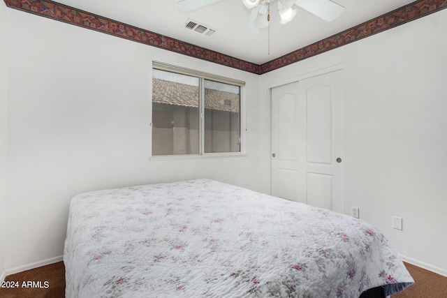 bedroom with ceiling fan, carpet flooring, and a closet