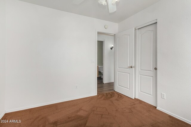 unfurnished bedroom with a closet and carpet floors