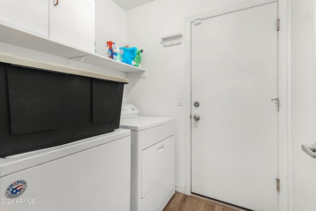 washroom featuring washing machine and clothes dryer and wood-type flooring