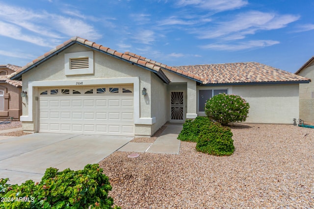 ranch-style house featuring a garage