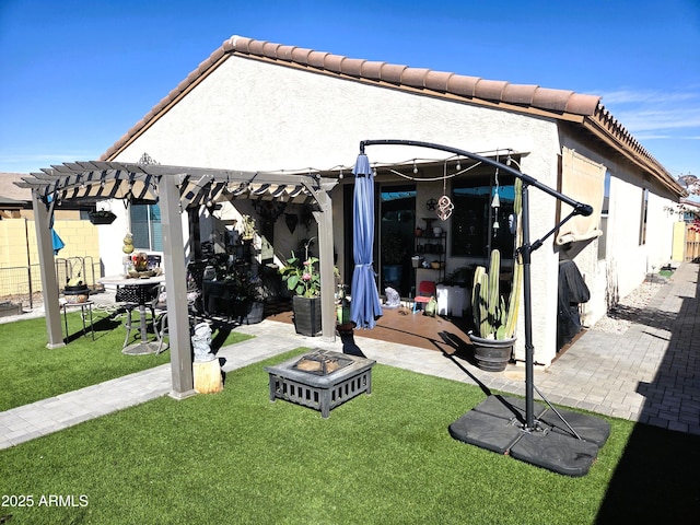 rear view of property featuring a tile roof, fence, a pergola, and a yard