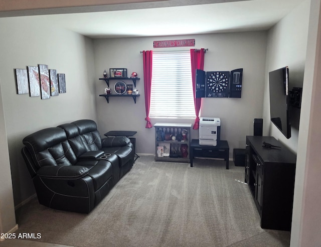 sitting room featuring carpet and baseboards