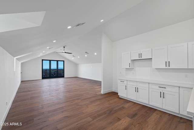 bonus room featuring lofted ceiling, visible vents, dark wood finished floors, and baseboards