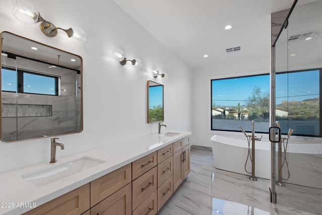 full bath with a wealth of natural light, visible vents, a shower stall, and a sink