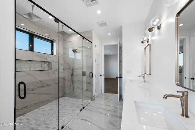 full bathroom featuring recessed lighting, a marble finish shower, a sink, and visible vents