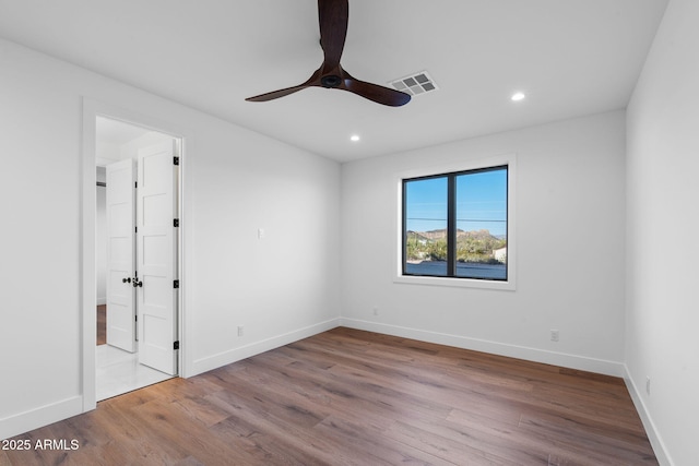 unfurnished room featuring recessed lighting, ceiling fan, visible vents, baseboards, and wood finished floors