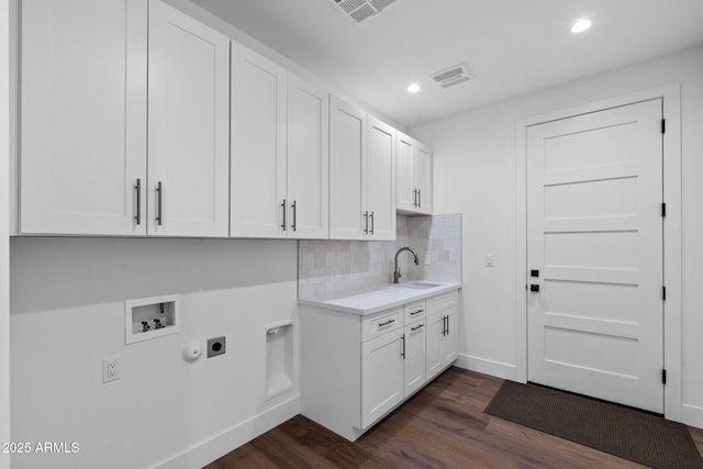washroom featuring a sink, cabinet space, washer hookup, electric dryer hookup, and visible vents