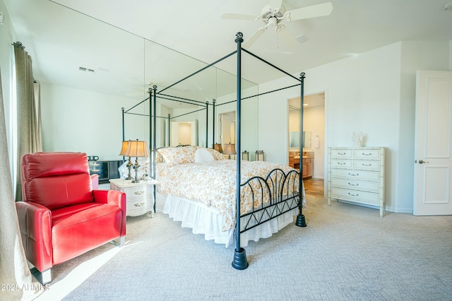 bedroom with connected bathroom and carpet flooring