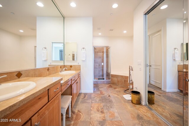 bathroom featuring vanity and a shower with door