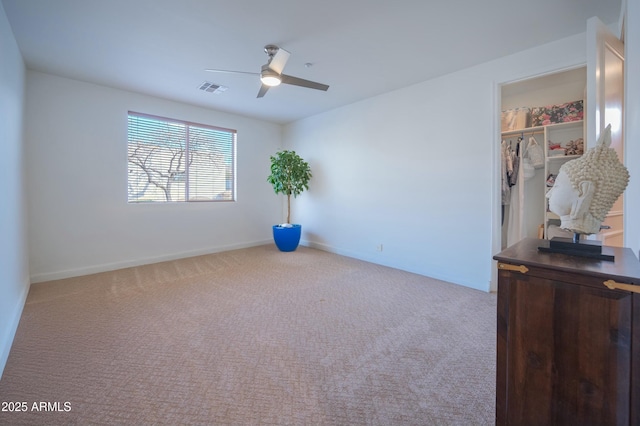 carpeted empty room with ceiling fan