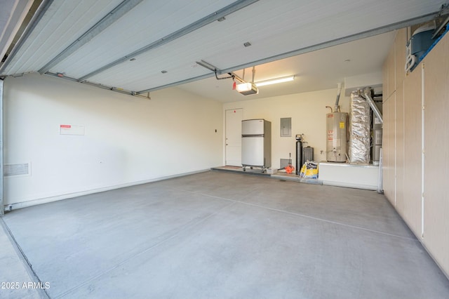 garage featuring water heater, a garage door opener, and refrigerator