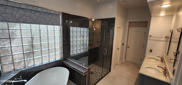 full bathroom featuring double vanity, a stall shower, a soaking tub, and a sink