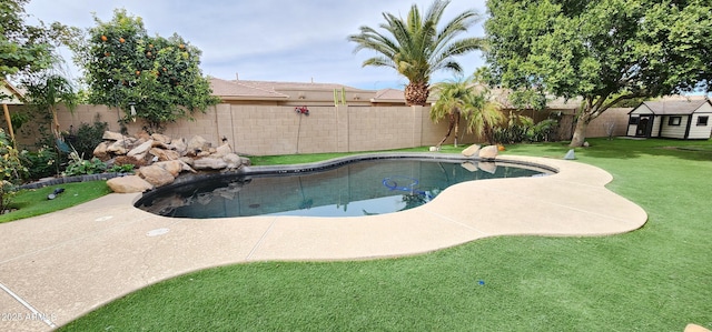 view of swimming pool with a fenced backyard, a fenced in pool, and a yard